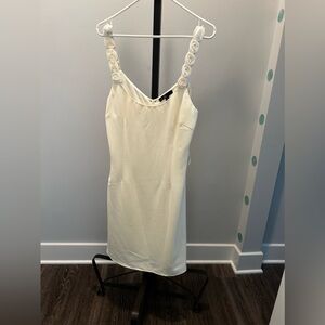 Light cream colored dress with detailed roses on straps.